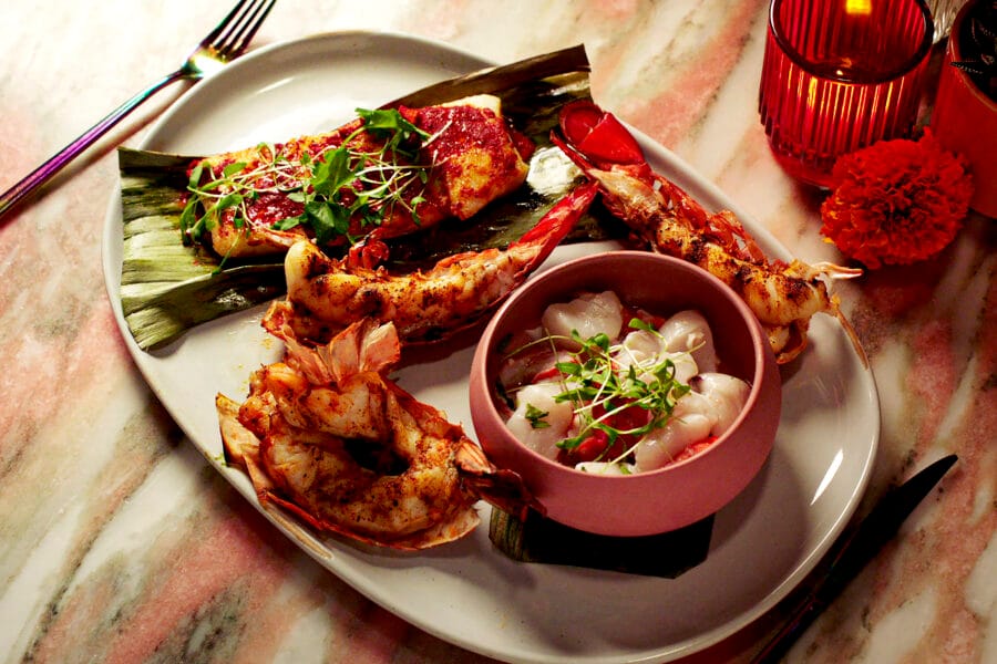 grilled lobster tails and vegetable garnish served on virgin voyages cruises