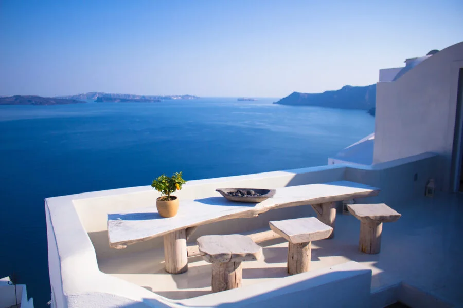 table and stools on veranda overlooking ocean